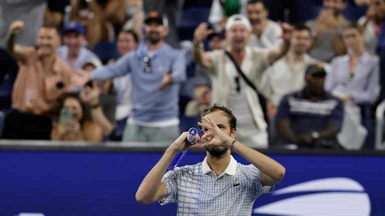 Medvedev gets the crowd going after some faulty footwork from a courtside photographer.