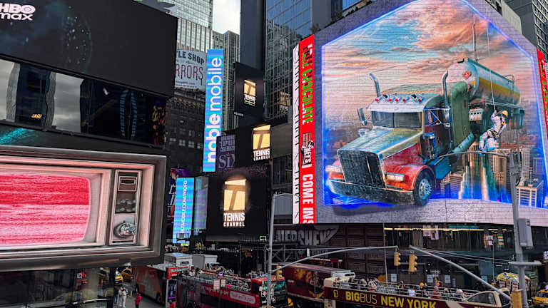 The screens are located at 711 Seventh Avenue, attached to the exterior of the Voco Hotel Times Square.